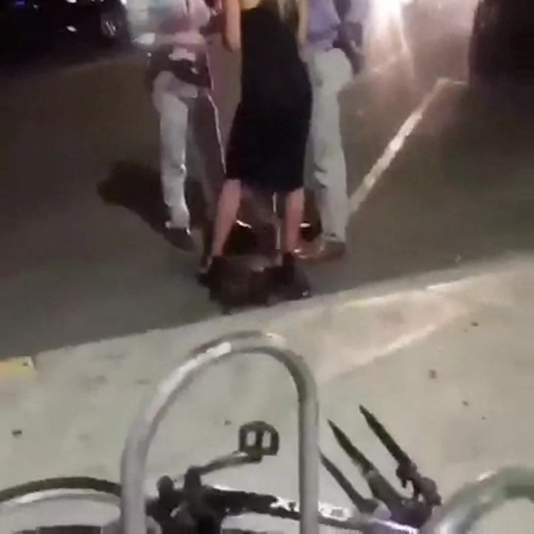 Pissing in the street like a dog while talking to two people